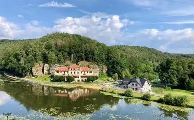 a house on a hill next to a river at Četnická Stanice Mšeno in Mšeno