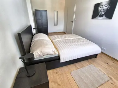 a small bedroom with a bed and a desk at Isabel's Suites in Prague