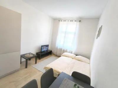 a living room with a bed and a table at Isabel's Suites in Prague