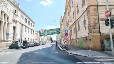 an empty city street with a traffic light and buildings at Isabel's Suites in Prague