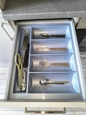 a drawer filled with utensils in a cabinet at Isabel's Suites in Prague