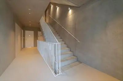 a staircase in a house with a metal railing at IndustriaLux Suite by Rentez in Prague