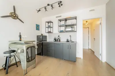 a kitchen with a sink and a counter top at IndustriaLux Suite by Rentez in Prague