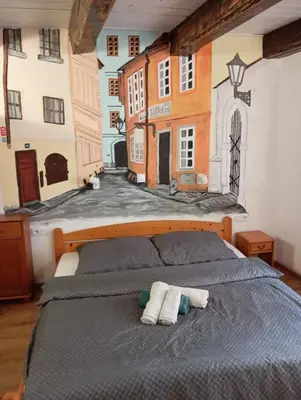 a bedroom with a bed with a painting on the wall at Prague centrum house in Prague