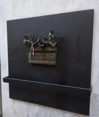 a plaque on a black wall with a clock on it at Prague centrum house in Prague