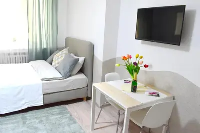 a living room with a couch and a table with flowers at Prague City Centre Apartment in Prague