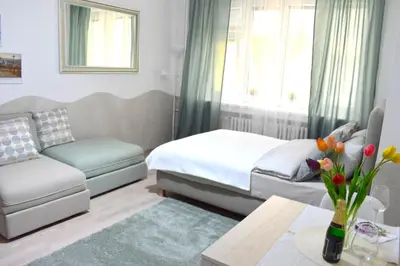 a bedroom with two beds and a couch and a table at Prague City Centre Apartment in Prague