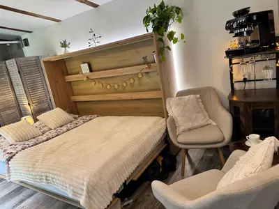a bedroom with a bed and a chair and a desk at Chillzóna u Medojeda in Chyňava