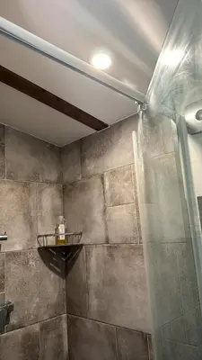 a shower with a glass door in a bathroom at Chillzóna u Medojeda in Chyňava