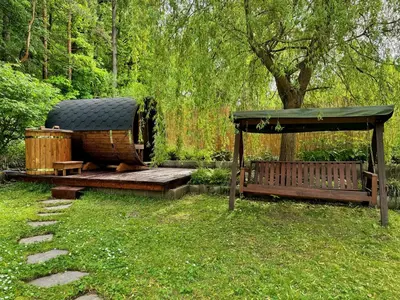 a garden with a gazebo and a wooden bench at Chillzóna u Medojeda in Chyňava