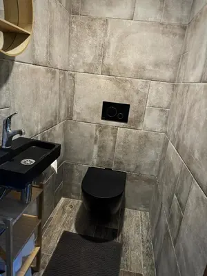 a bathroom with a toilet and a sink at Chillzóna u Medojeda in Chyňava