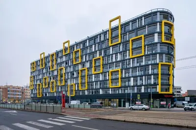 a large yellow building with a sign that reads hotel at Prague Centre Luxury Apartment & Parking in Prague