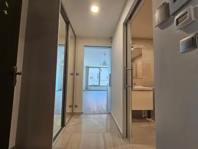 a hallway with a door to a kitchen with a sink at Prague Centre Luxury Apartment & Parking in Prague