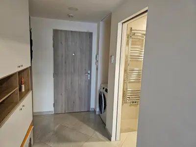 a kitchen with a washer and dryer next to a door at Prague Centre Luxury Apartment & Parking in Prague