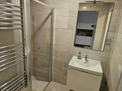 a bathroom with a shower and a sink and a mirror at Prague Centre Luxury Apartment & Parking in Prague