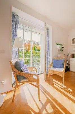 a living room with a chair and a window at Romantický apartmán se starožitným interiérem in Mořina