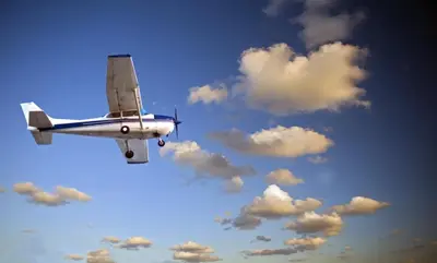 a small plane flying in a cloudy sky at Romantický apartmán se starožitným interiérem in Mořina