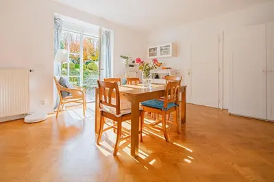 a kitchen and dining room with a table and chairs at Romantický apartmán se starožitným interiérem in Mořina