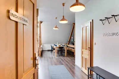 a hallway with a door and a dining room at Ultimate Prague 1 experience - Duplex, Roof Top Terrace, Prague Castle View, free parking over weekends, AC! in Prague