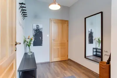 a hallway with a door and a vase of flowers at Ultimate Prague 1 experience - Duplex, Roof Top Terrace, Prague Castle View, free parking over weekends, AC! in Prague