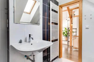 a bathroom with a sink and a mirror at Ultimate Prague 1 experience - Duplex, Roof Top Terrace, Prague Castle View, free parking over weekends, AC! in Prague
