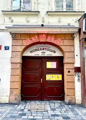 a building with a door with a sign above it at Koreatown in Prague