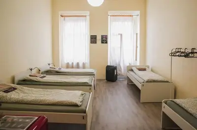 a room with four beds and two windows at Koreatown in Prague