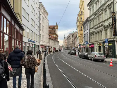 a group of people walking down a city street at Koreatown in Prague