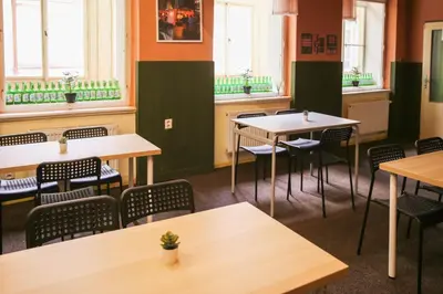 a dining room with tables and chairs and windows at Koreatown in Prague