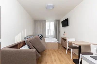 a small living room with a couch and a table at SKYLINE PRAGUE Apartments in Prague