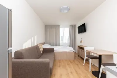a living room with a couch and a bed at SKYLINE PRAGUE Apartments in Prague