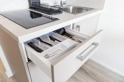 a kitchen with a white counter and a sink at SKYLINE PRAGUE Apartments in Prague