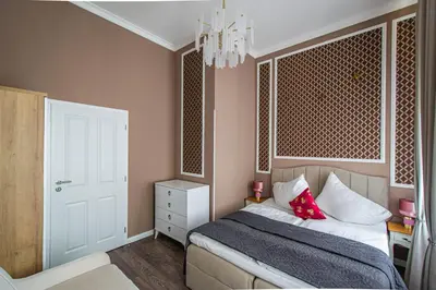 a bedroom with a bed and a chandelier at 3BDR Elegance Deco Downtown Flat in Prague