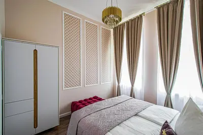 a bedroom with a bed and a large window at 3BDR Elegance Deco Downtown Flat in Prague