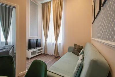 a living room with a couch and a tv at 3BDR Elegance Deco Downtown Flat in Prague