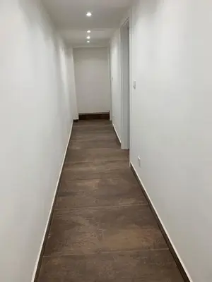 an empty hallway with white walls and a wooden floor at T1-Wenceslas square in Prague