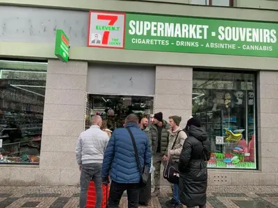 a group of people standing outside of a store at T1-Wenceslas square in Prague