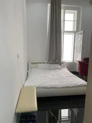 a white bed in a room with a window at T1-Wenceslas square in Prague