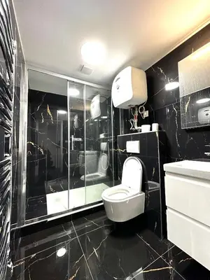 a black bathroom with a toilet and a shower at T1-Wenceslas square in Prague