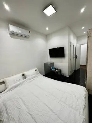 a bedroom with a white bed and a television at T1-Wenceslas square in Prague