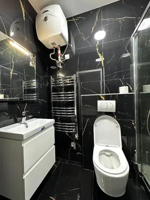 a black bathroom with a toilet and a sink at T1-Wenceslas square in Prague