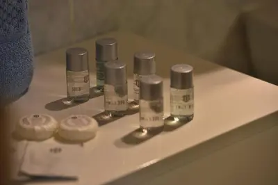 a group of four bottles on a bathroom counter at Old Town Apartments Tyn in Prague