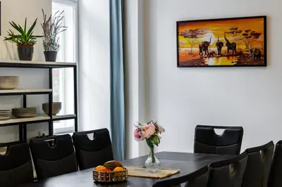 a dining room with a table with a vase of flowers at Large Historic Home by Charles Bridge & Parking in Prague