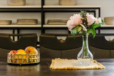 a vase with flowers and a basket of fruit on a table at Large Historic Home by Charles Bridge & Parking in Prague