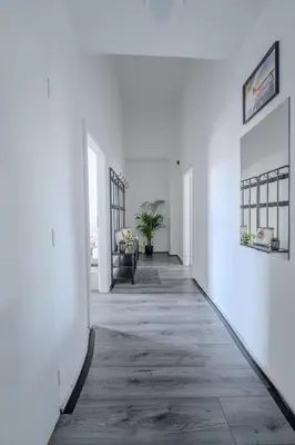 an empty hallway with white walls and a table at Large Historic Home by Charles Bridge & Parking in Prague