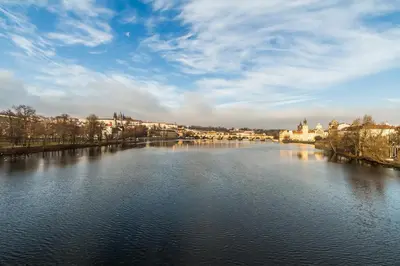 a view of a river in a city with buildings at Large Historic Home by Charles Bridge & Parking in Prague
