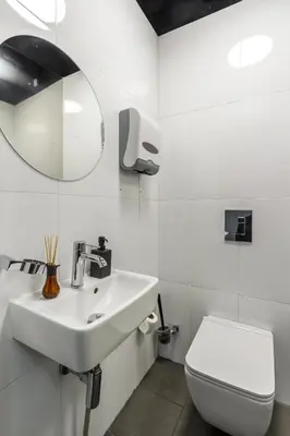 a white bathroom with a sink and a toilet at Large Historic Home by Charles Bridge & Parking in Prague