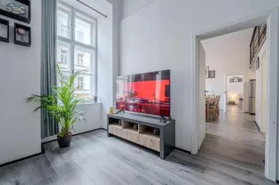 a living room with a large aquarium in a white room at Large Historic Home by Charles Bridge & Parking in Prague