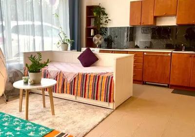 a kitchen with a bed with a table in it at Green Studio Praha 2 l Ground floor Free PARKING in Prague