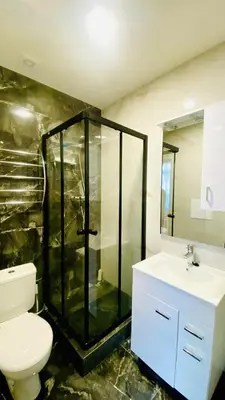 a bathroom with a shower and a toilet and a sink at Green Studio Praha 2 l Ground floor Free PARKING in Prague